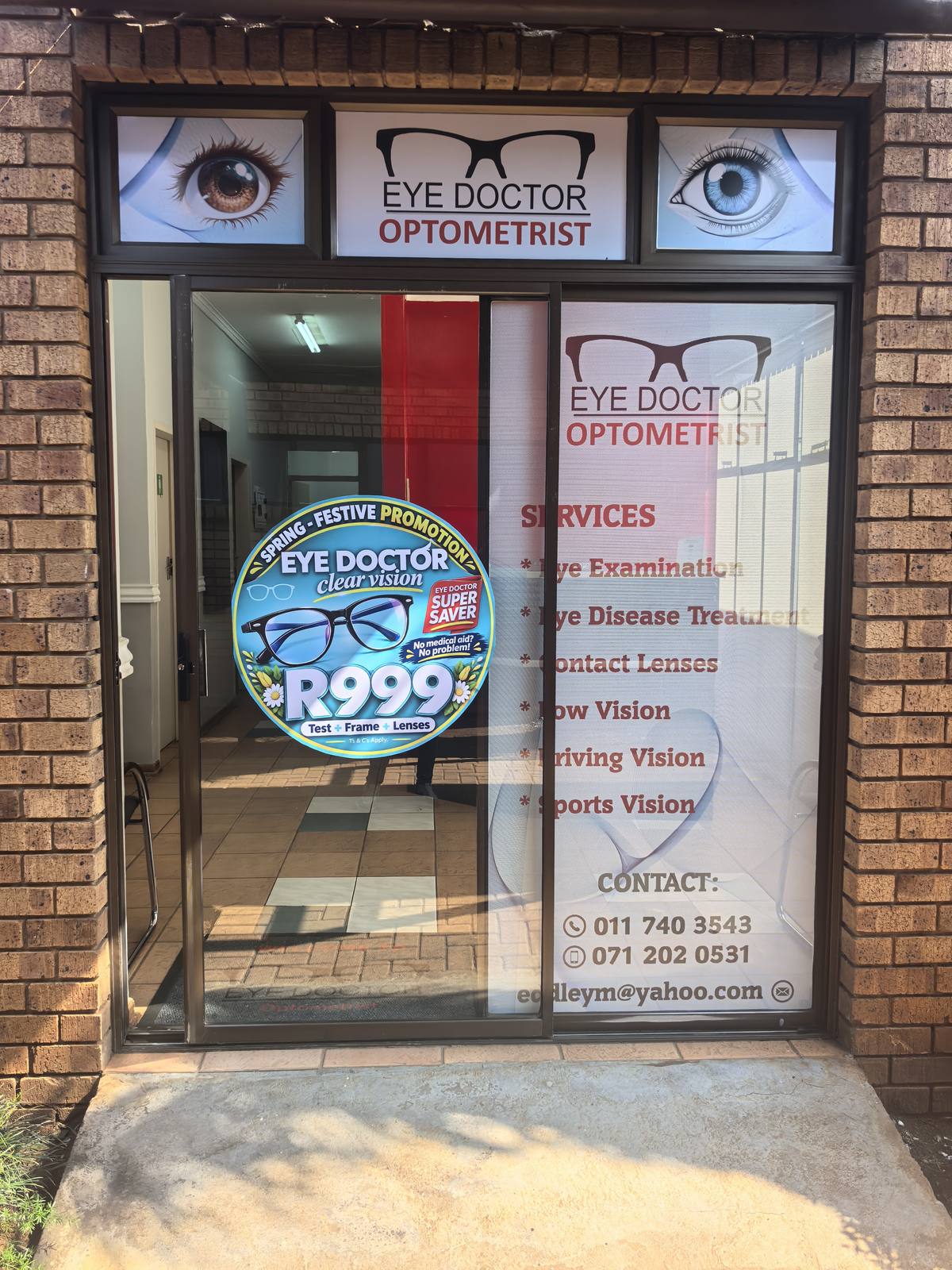 Eye Doctor shopfront lettering and window graphics with a circular promotional display.